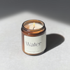 Species by the Thousands Water Elemental Magic Candle in an amber jar with a minimal beige paper label