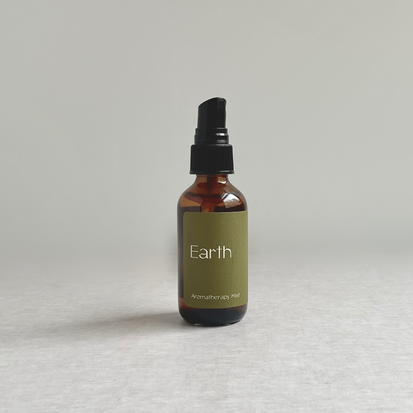 Species by the Thousands Earth Aromatherapy Mist in amber glass bottle  with sap green label.