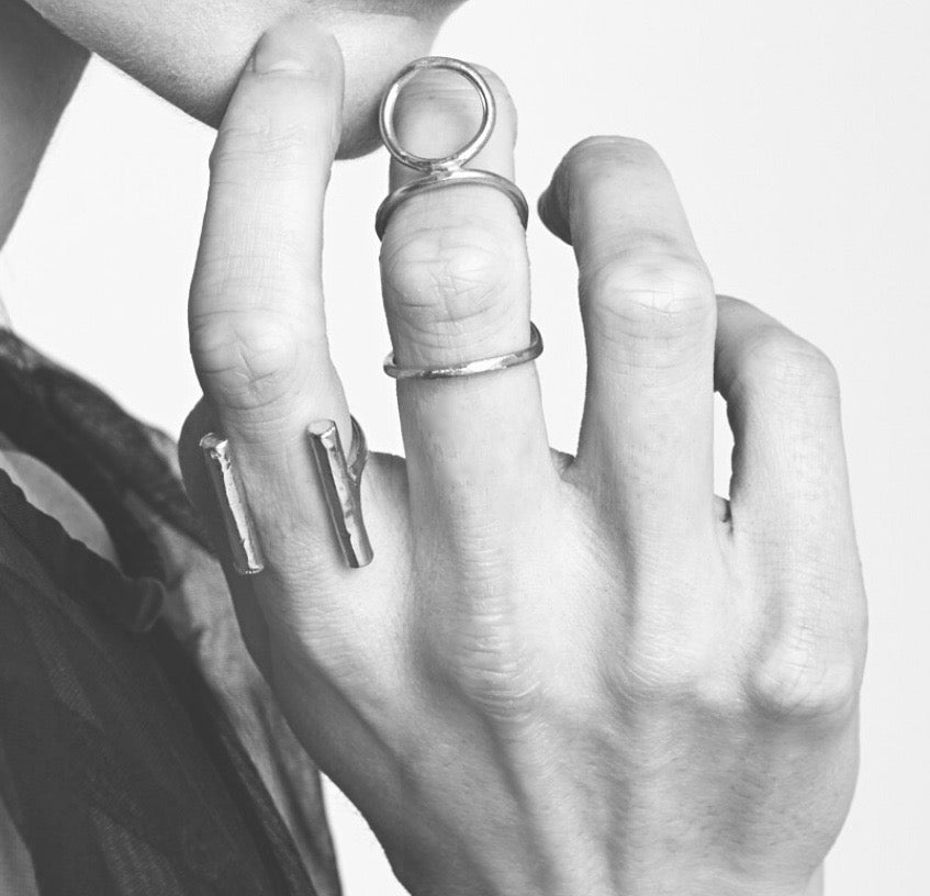 Species by the Thousands Orb Ring and Parallel Bar Ring in brass on model..