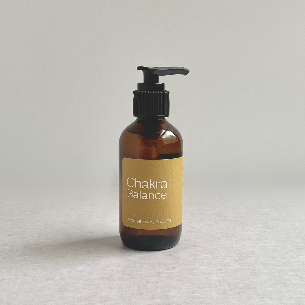 Species by the Thousands Chakra Balance essential oil body oil in an amber glass bottle with a gold label.