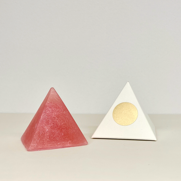 Golda red  pyramid shaped soap with white pyramid shaped box with gold circle.
