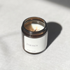 Species by the Thousands Energy Magic Candle in an amber jar with a minimal white paper label.